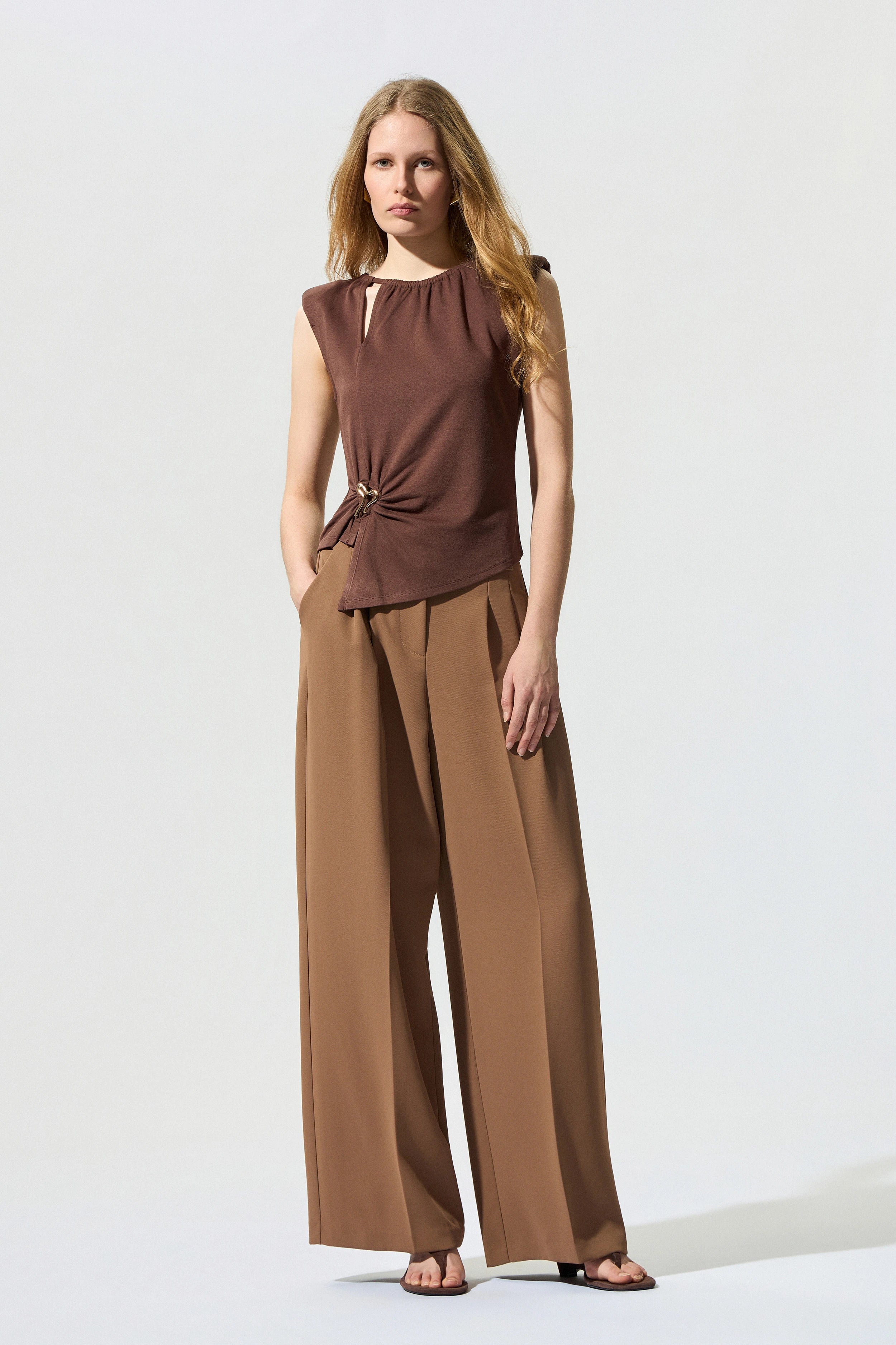 Sleeveless blouse with decorative buckle