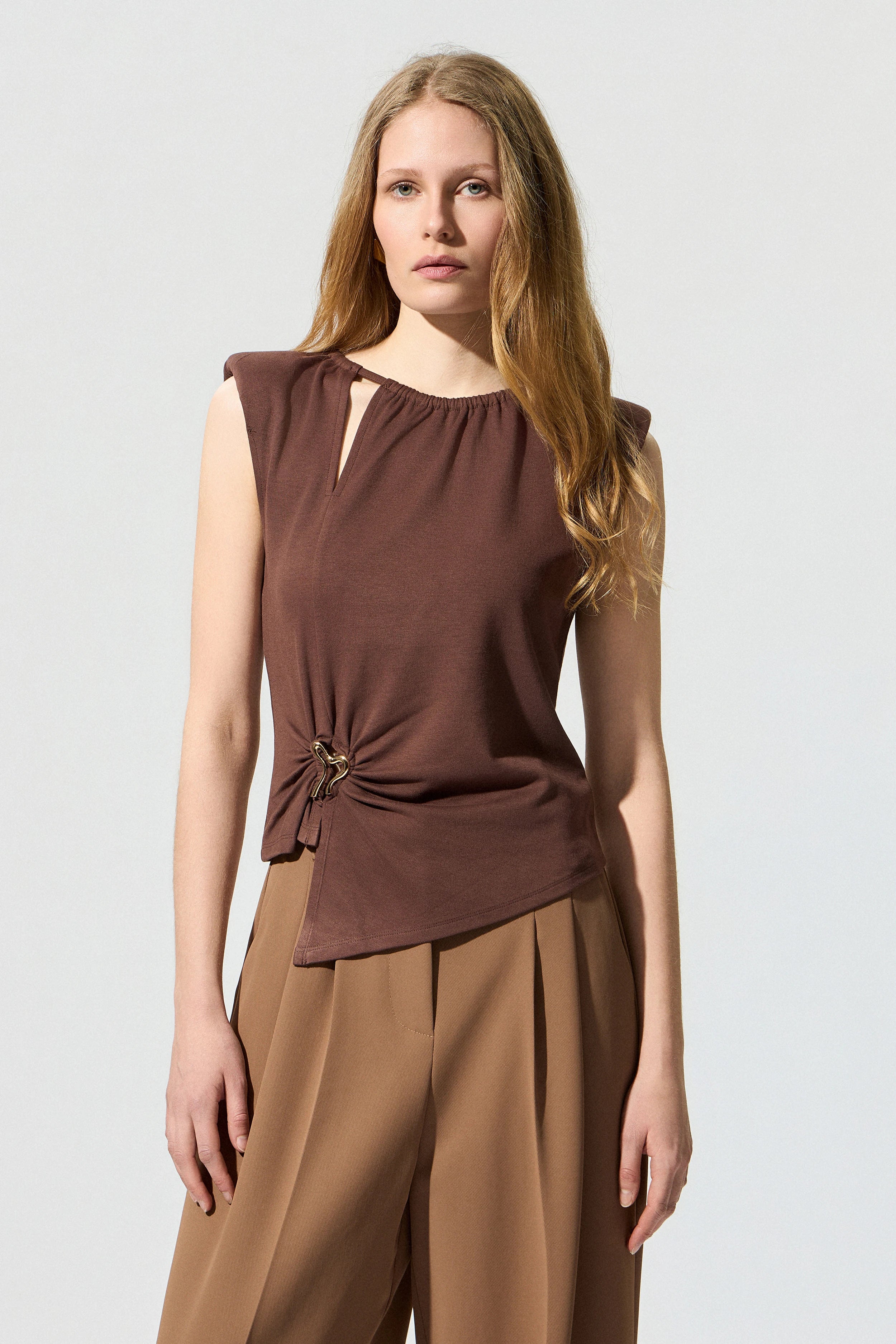 Sleeveless blouse with decorative buckle
